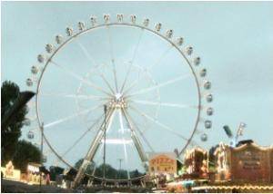 Here is a picture of a Ferris wheel. It has a diameter of 80 meters.

About how far does a rider t
